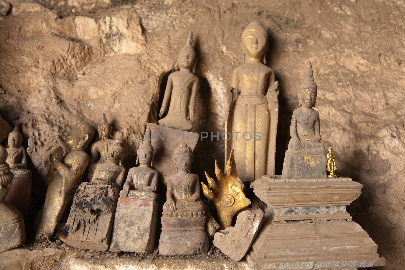 Ou Pak Caves Laos with small and miniature Buddha statues in many different pose by kgboxford