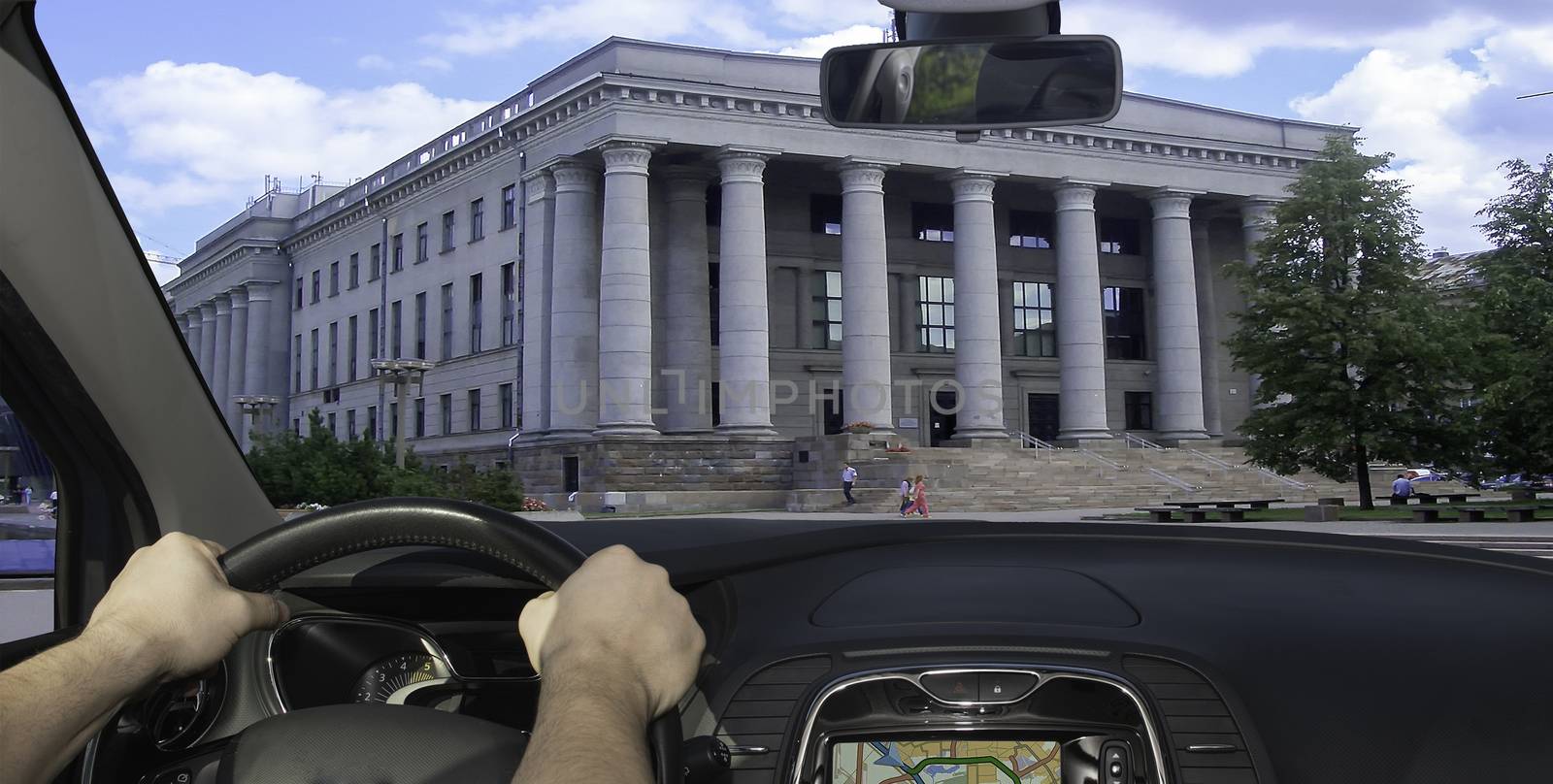 Driving a car towards the facade of the Martynas Mažvydas National Library, Vilnius, Lithuania