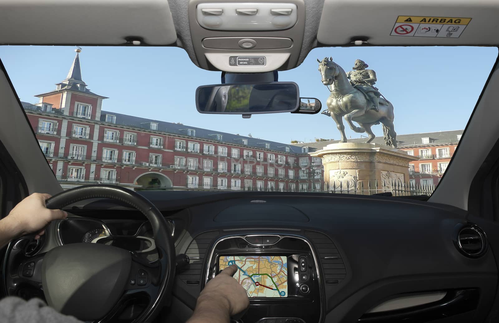Driving while using navigation system in Plaza Mayor, Madrid, Sp by marcorubino