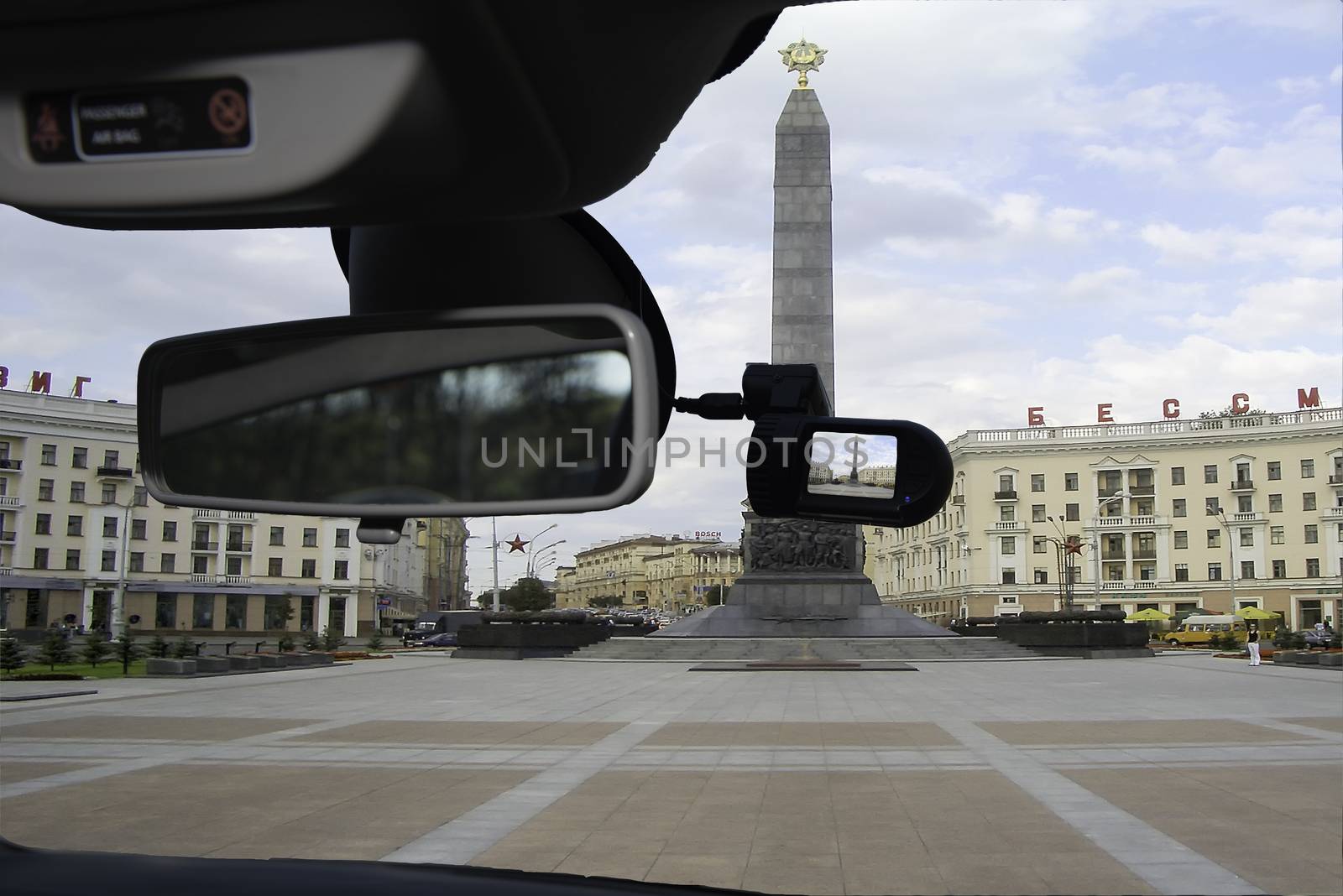 Looking through a dashcam car camera installed on a windshield with view of Victory Square and the iconic Obelisk, one of the main landmarks in Minsk, Belarus