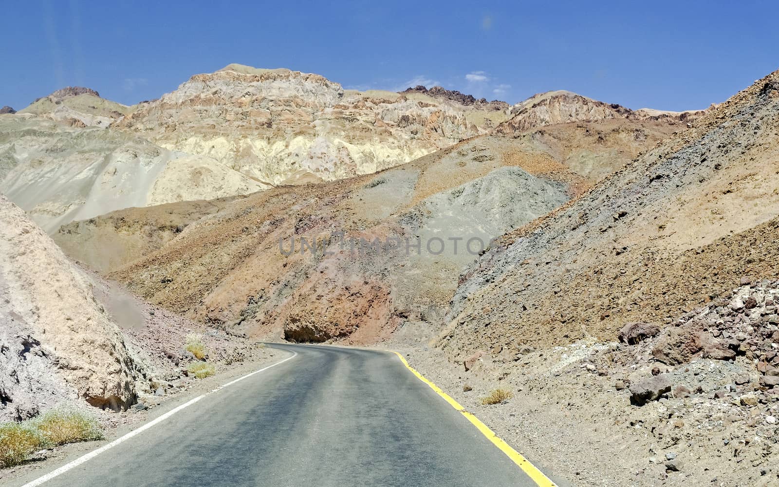 Isolated road among the rocks in Death Valley, USA by marcorubino