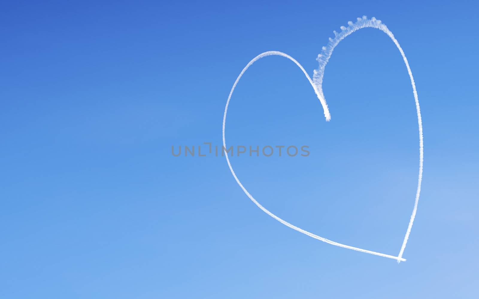 Romantic heart written by an aircraft in the sky, with copy space. Concept for Valentine's day