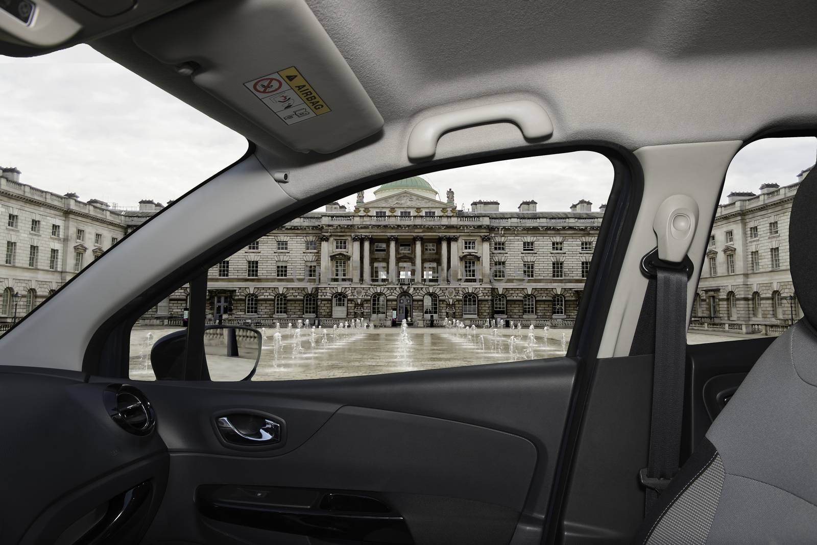 Looking through a car window with view of Somerset House, Victorian building in the Strand district of London, UK