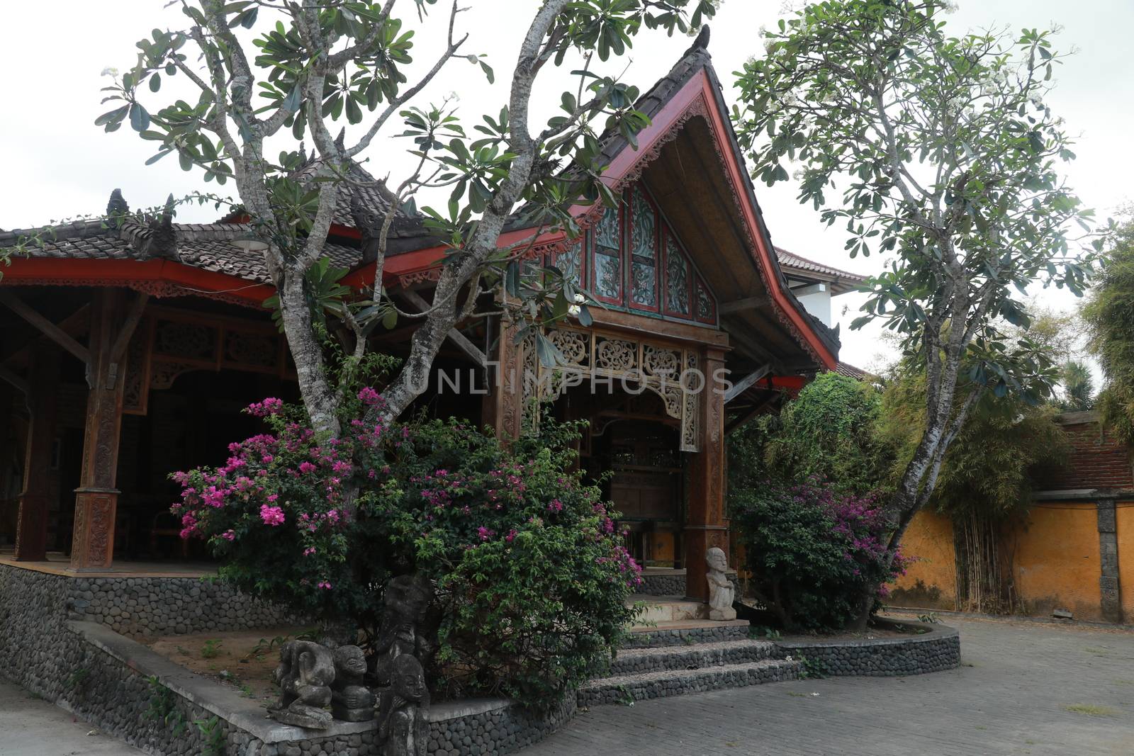 One of the traditional houses that is still preserved in the village. Traditional wooden house in a tropical garden on Lombok island, Indonesia.