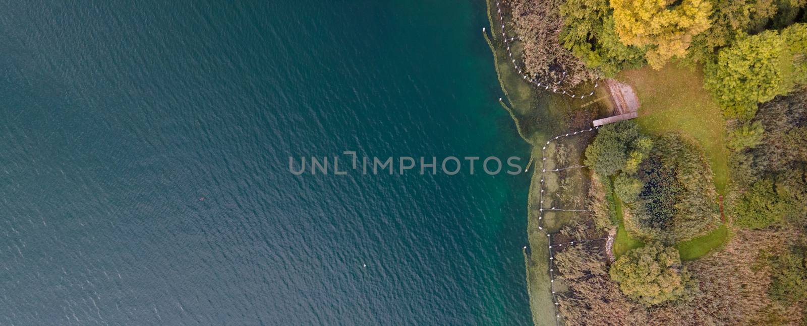 drone shot of people swimming in lake. Copy space by PeterHofstetter