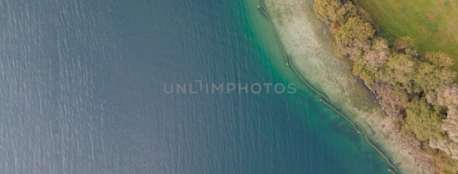 Drone shot over water. Background of lake. Birds view. Copy Space by PeterHofstetter