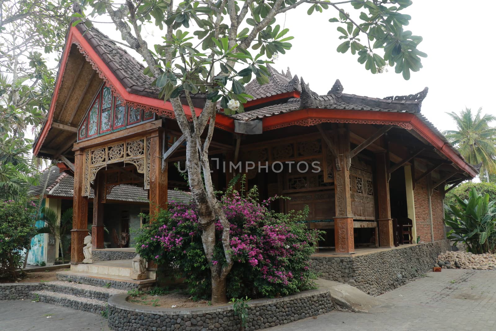 One of the traditional houses that is still preserved in the village. Traditional wooden house in a tropical garden on Lombok island, Indonesia.