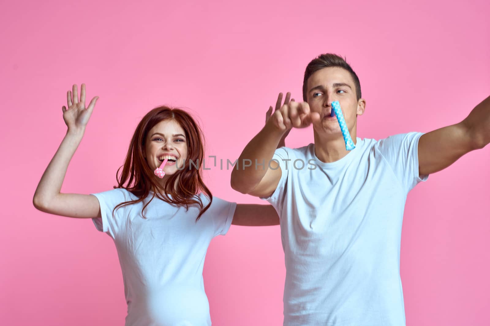 pregnant mom and happy father on pink background Young family waiting for baby. High quality photo