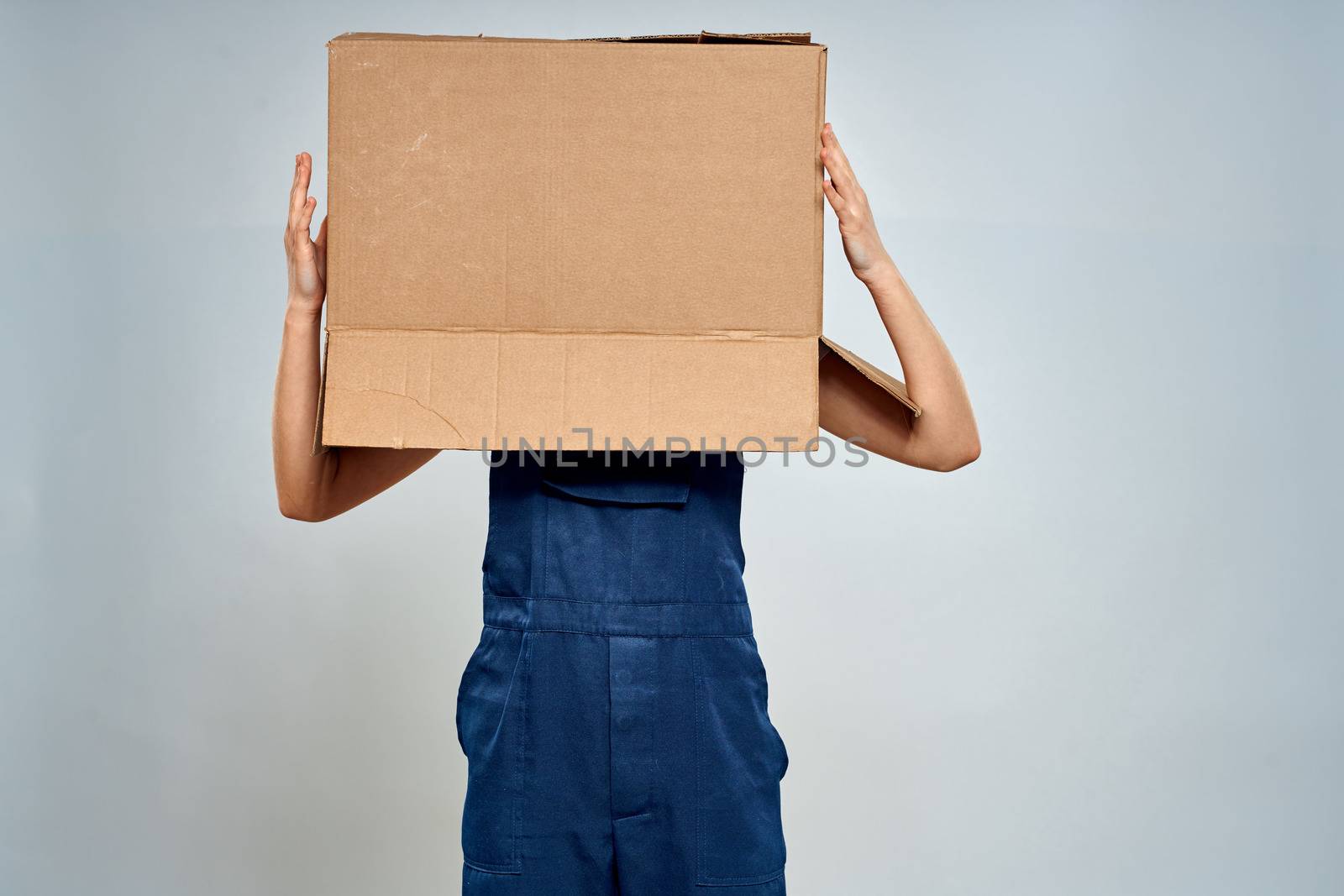 Woman in working uniform box packing service lifestyle by SHOTPRIME