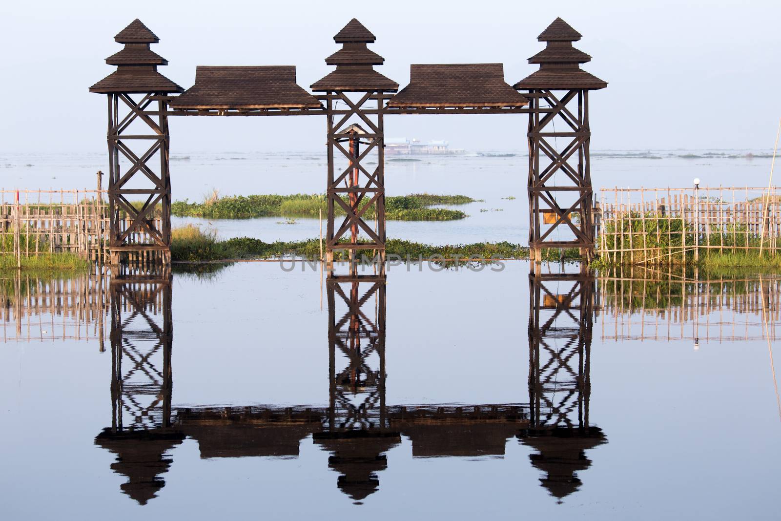 Inle Lake Myanmar 12/16/2015 Shwe Inn Tha Floating Resort. Beautiful traditional buildings on stilts on the lake photograped early morning with clear reflections. High quality photo