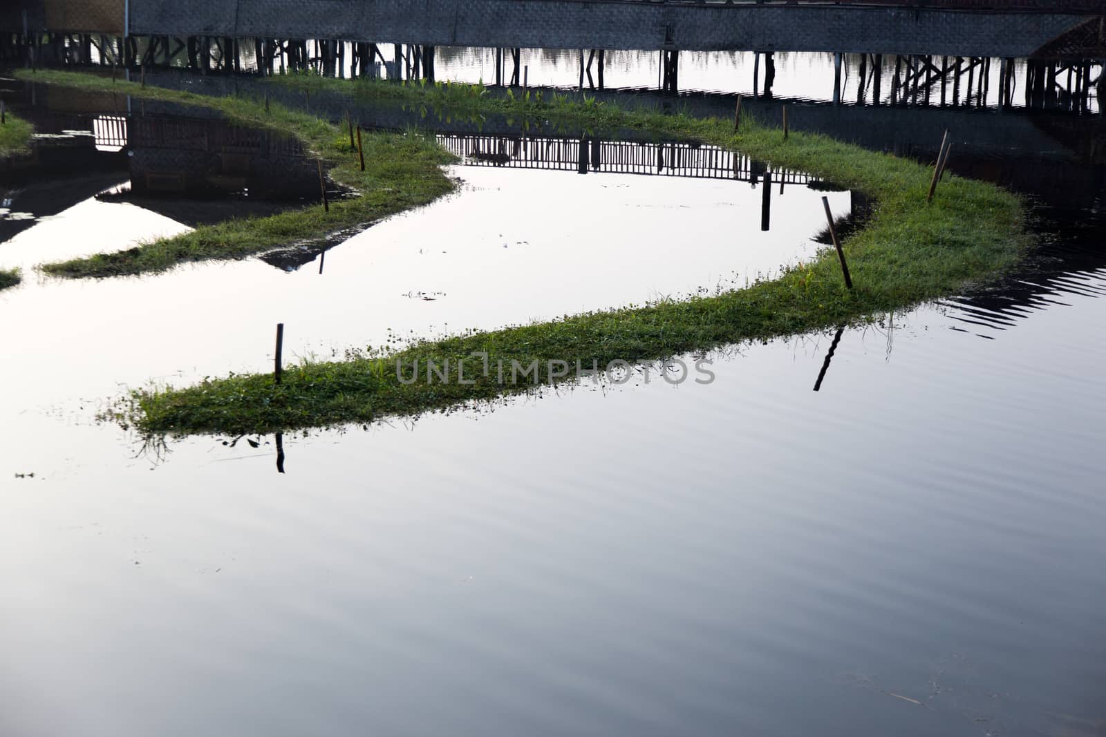 Inle Lake Myanmar 12/16/2015 Shwe Inn Tha Floating Resort. Beautiful traditional buildings on stilts on the lake photograped early morning with clear reflections. High quality photo