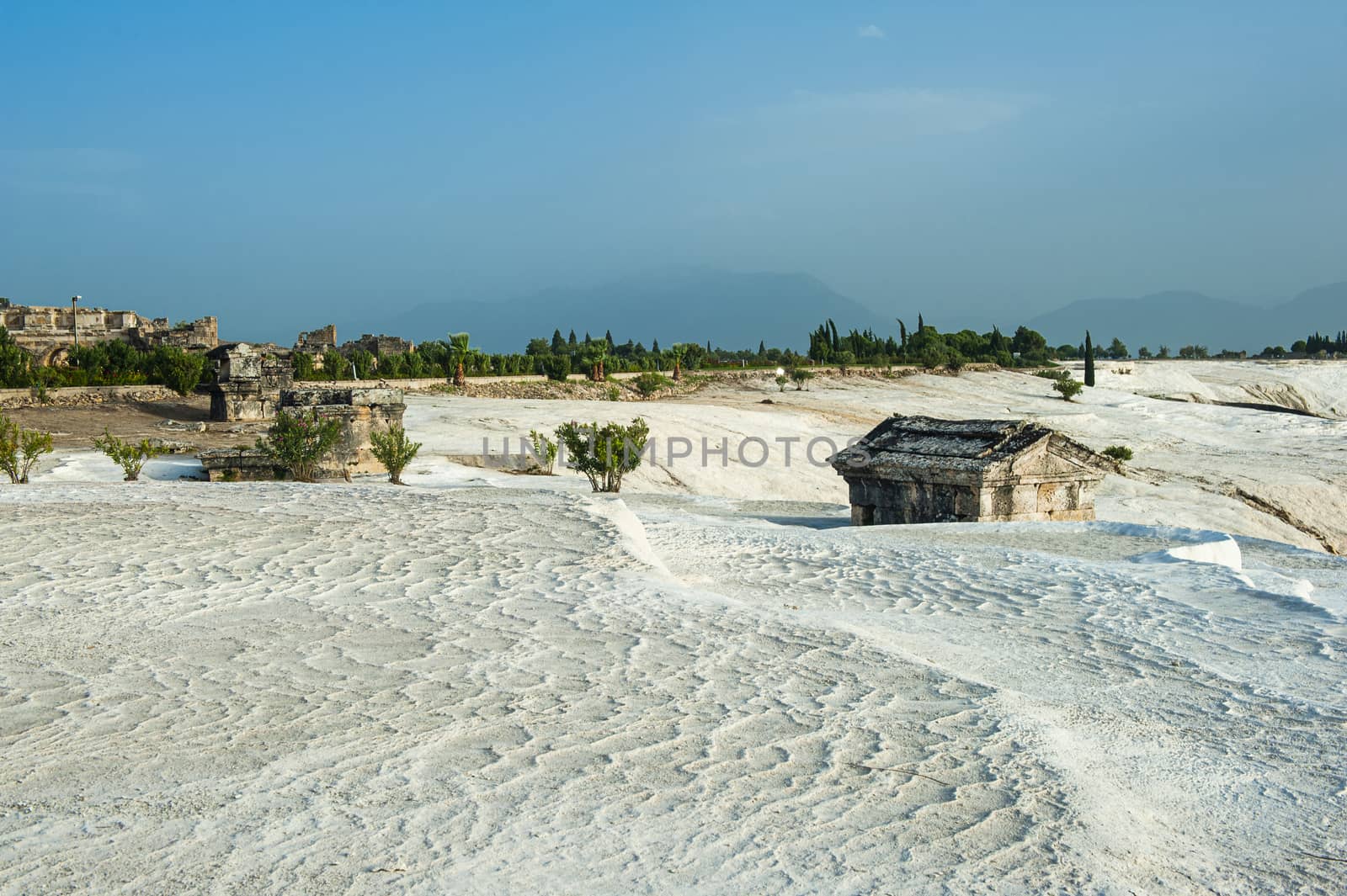 Pamukkale (cotton castle) natural wonder is created by a layers of white travertine looking like cotton, Turkey. There are ancient Roman ruins of Hierapolis nearby