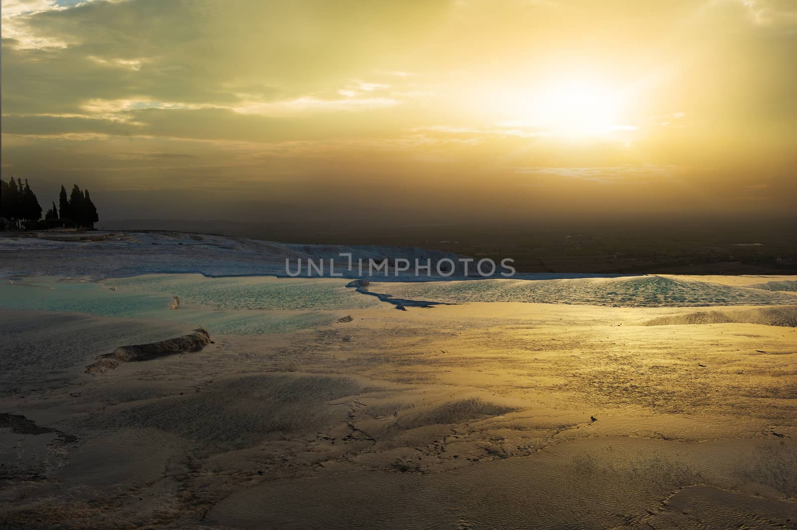 Beautiful vivid sunset over the travertine terraces and pools at Pamukkale, Turkey
