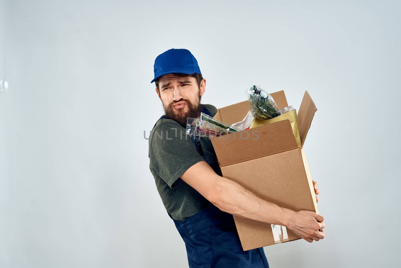 Male worker loading delivery boxes in hands packing lifestyle. High quality photo