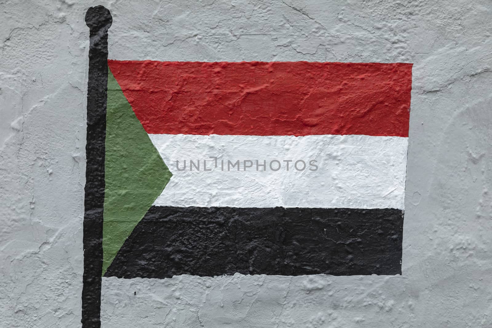 Childish style drawing, of the flag of Sudan, painted on a wall.