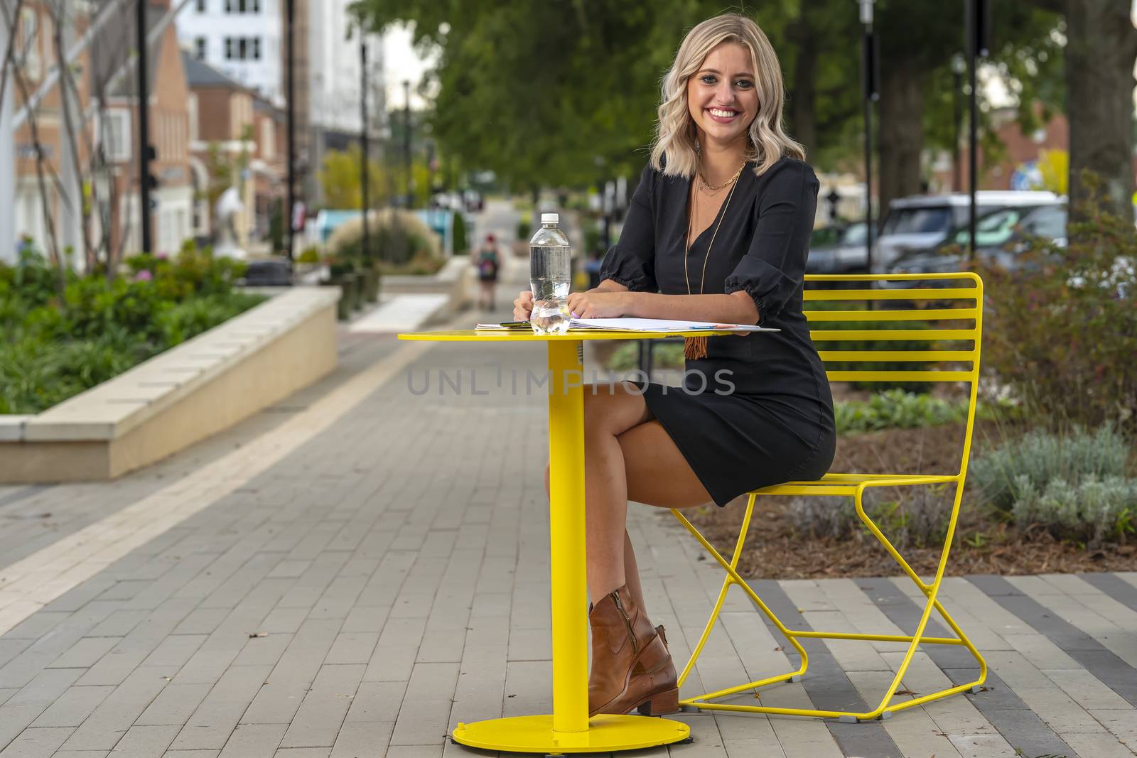 A gorgeous blonde model poses outdoors in her fall clothes