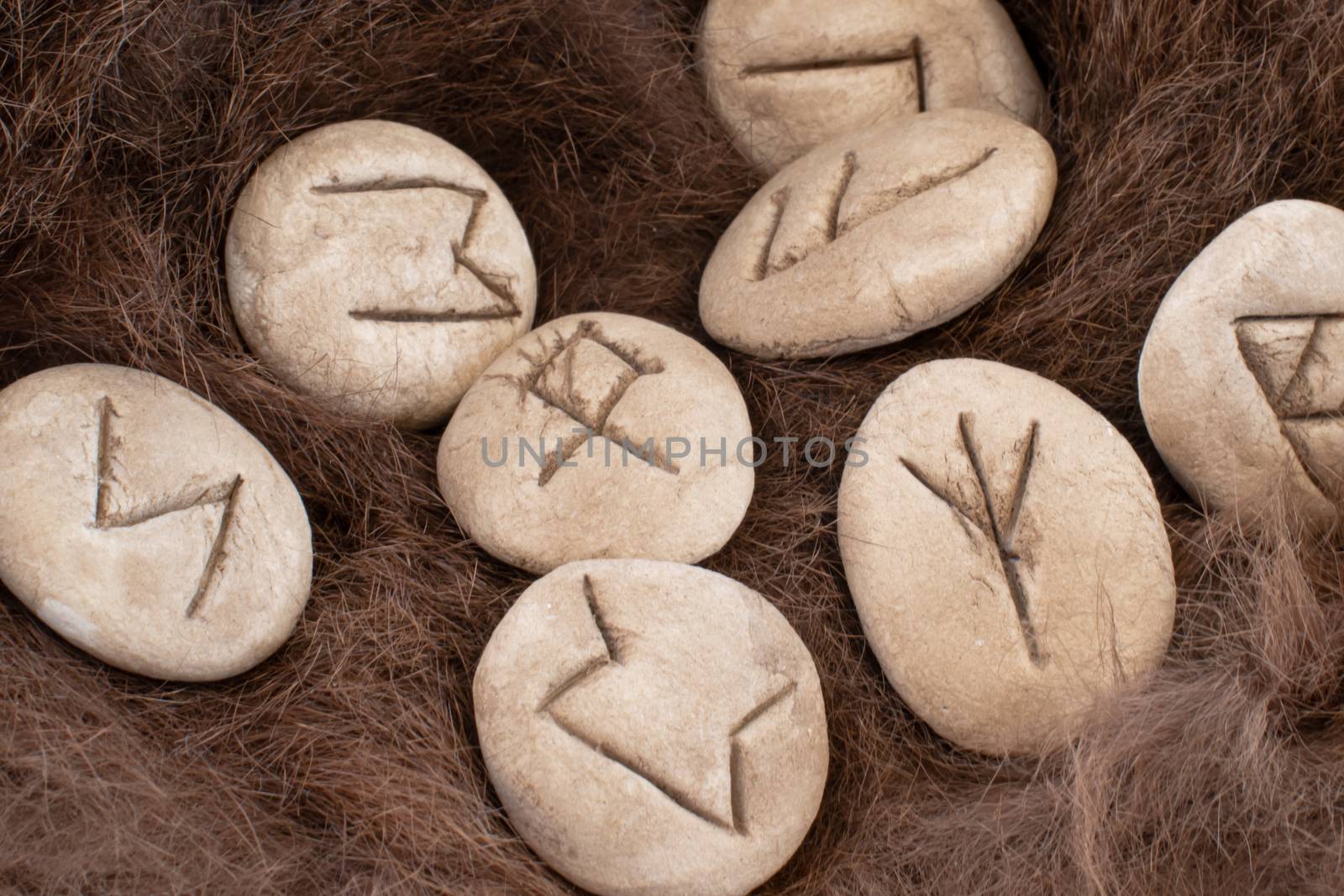 Stone runes on a fur. Futhark viking alphabet. Close up photo of Norse runes.