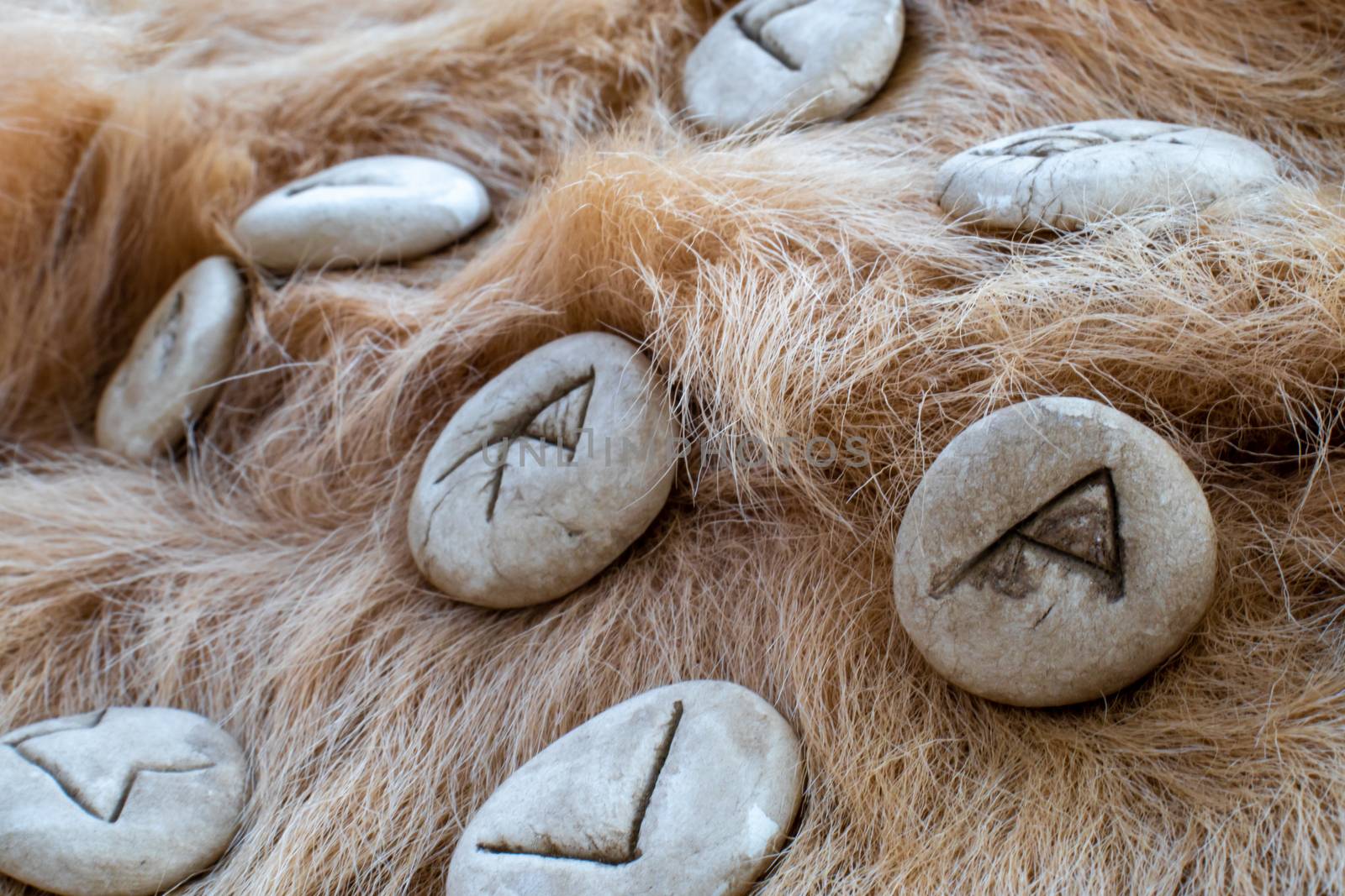 Stone runes on a fur. Futhark viking alphabet. Close up photo of Norse runes.