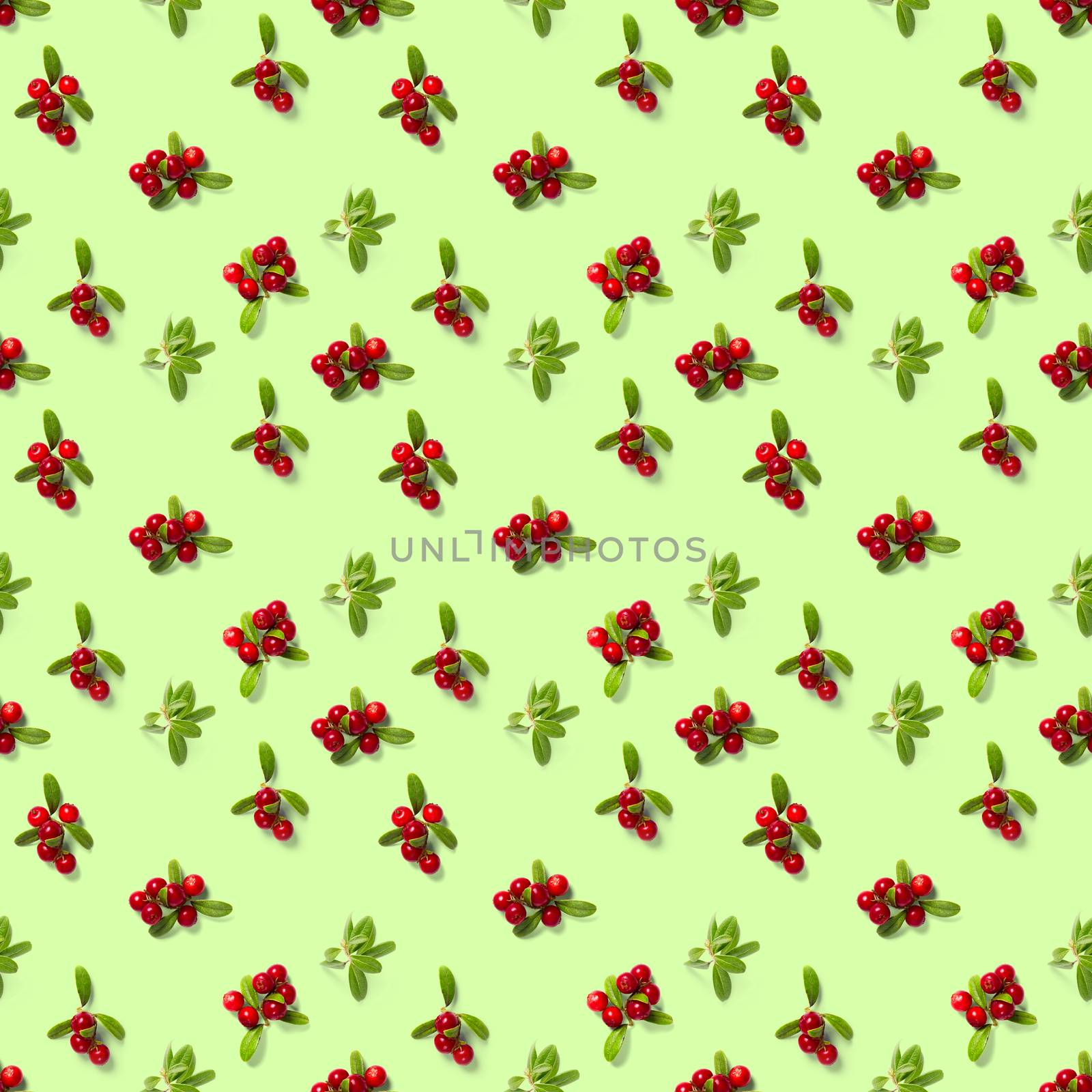 Lingonberry seamless pattern on green background. Fresh cowberries or cranberries with leaves as seamless pattern for textile, fabric, print or posters