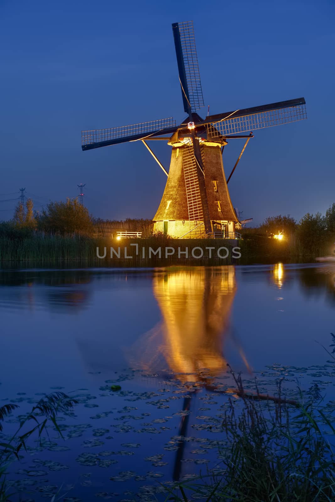 Illuminated windmill at Kinderdijk, The Netherlands. by emiddelkoop