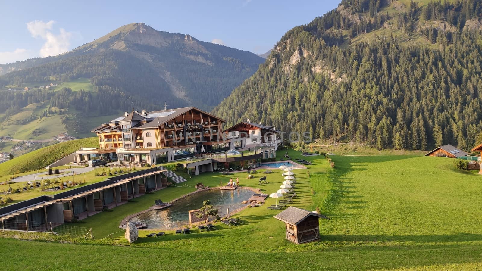 Val Gardena, Italy - 09/15/2020: Scenic alpine place with magical Dolomites mountains in background, amazing clouds and blue sky in Trentino Alto Adige region, Italy, Europe