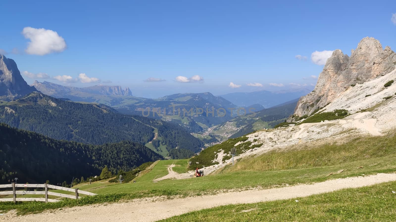 Val Gardena, Italy - 09/15/2020: Scenic alpine place with magical Dolomites mountains in background, amazing clouds and blue sky in Trentino Alto Adige region, Italy, Europe