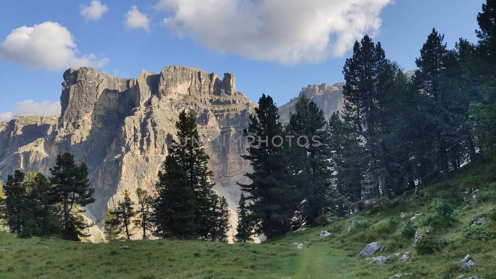 Val Gardena, Italy - 09/15/2020: Scenic alpine place with magical Dolomites mountains in background, amazing clouds and blue sky in Trentino Alto Adige region, Italy, Europe