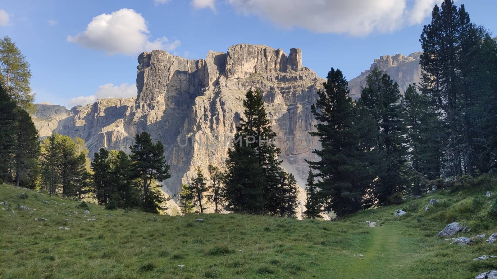 Val Gardena, Italy - 09/15/2020: Scenic alpine place with magical Dolomites mountains in background, amazing clouds and blue sky in Trentino Alto Adige region, Italy, Europe