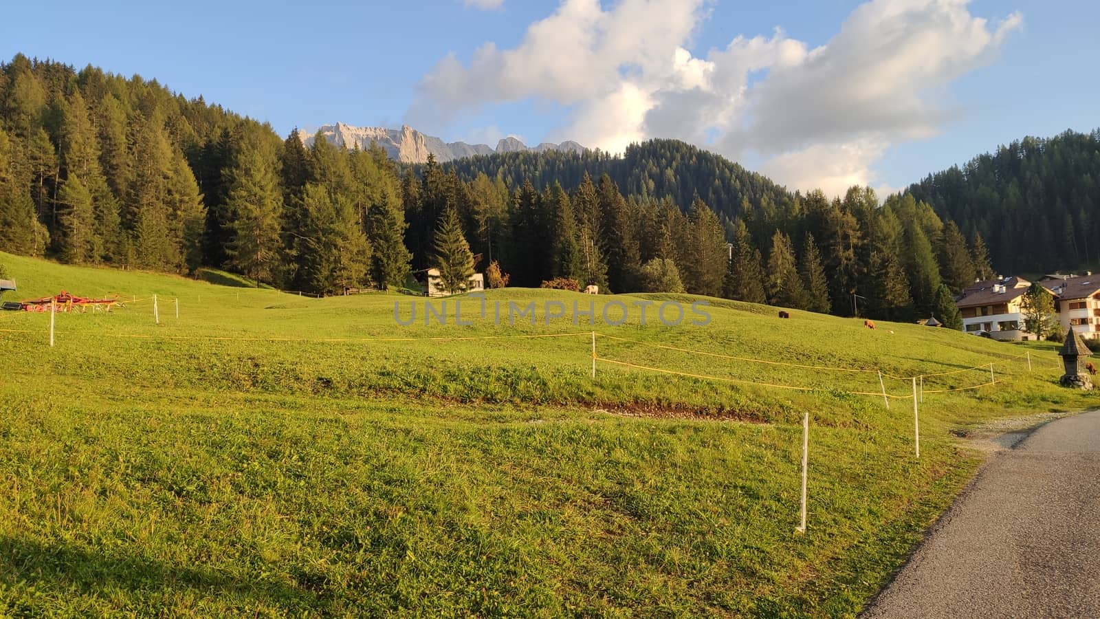 Val Gardena, Italy - 09/15/2020: Scenic alpine place with magical Dolomites mountains in background, amazing clouds and blue sky in Trentino Alto Adige region, Italy, Europe