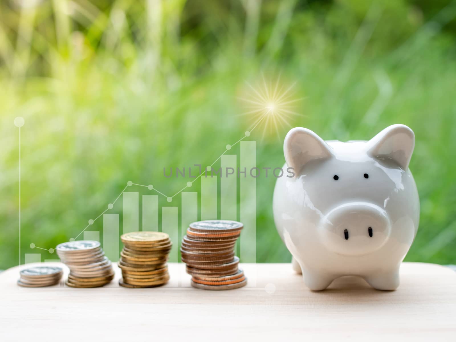 Piggy bank and Money coins with stack growing graph and nature b by Unimages2527