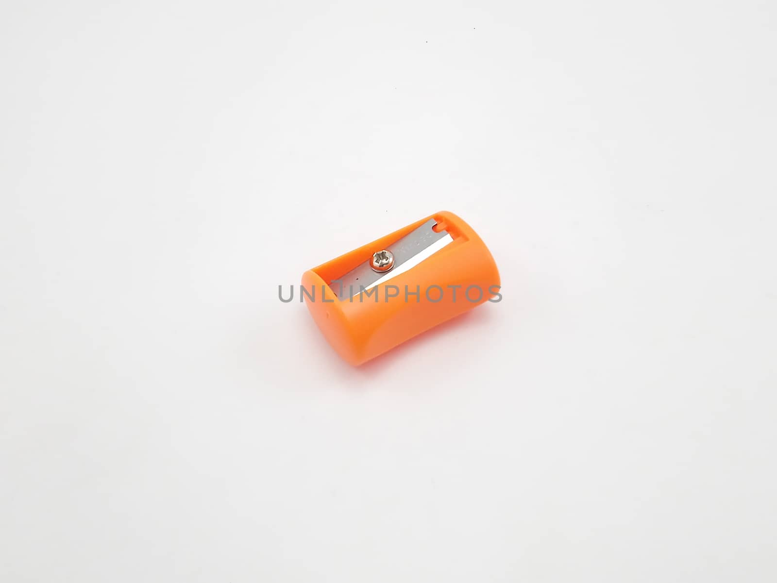 Orange manual hand operated pencil sharpener use to sharpen dull pencils