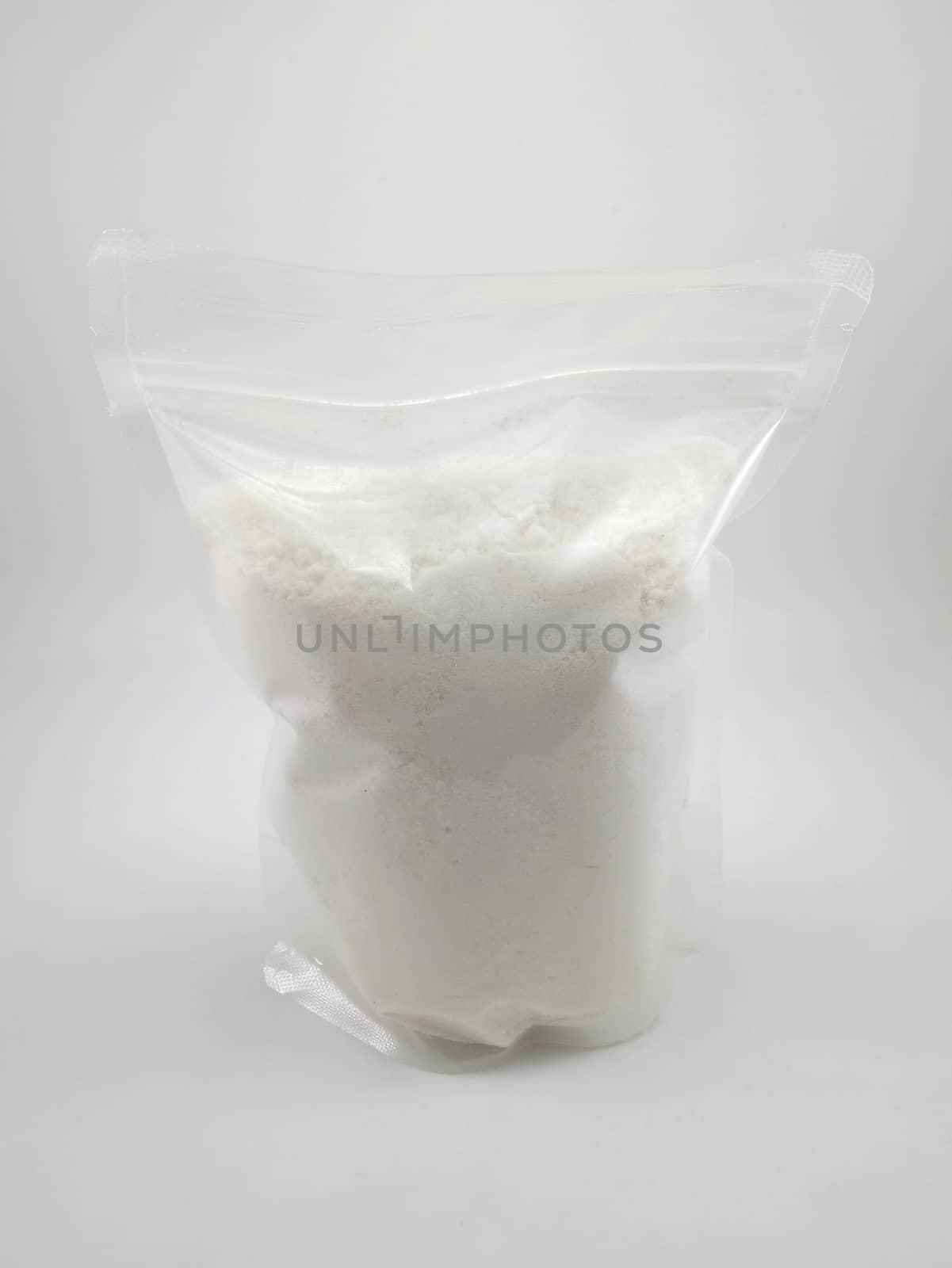 White gentle laundry powder in clear plastic pack use to clean baby fabric clothes 