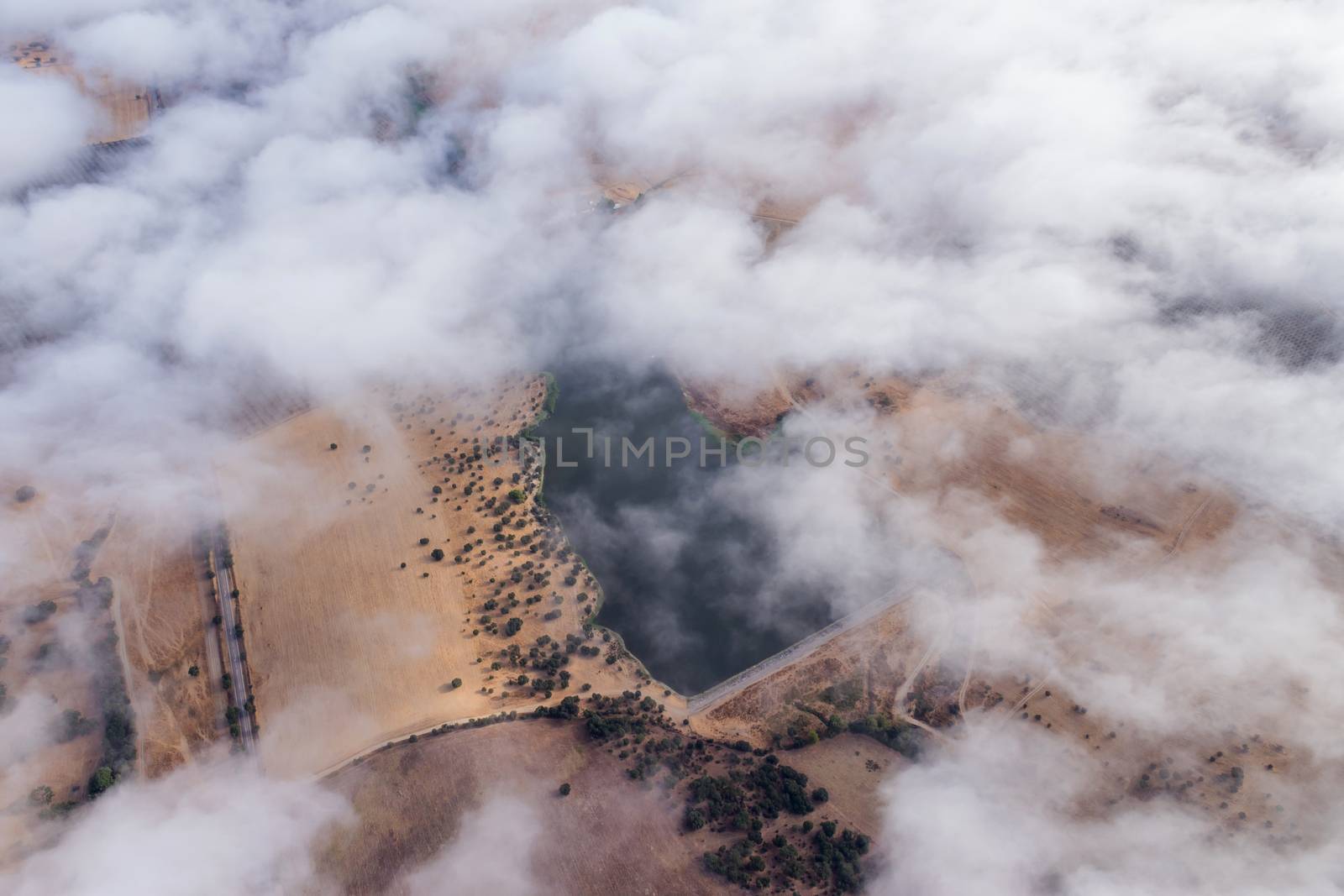 Hot air balloon in the Alentejo region, above the clouds and the fields. Portugal.