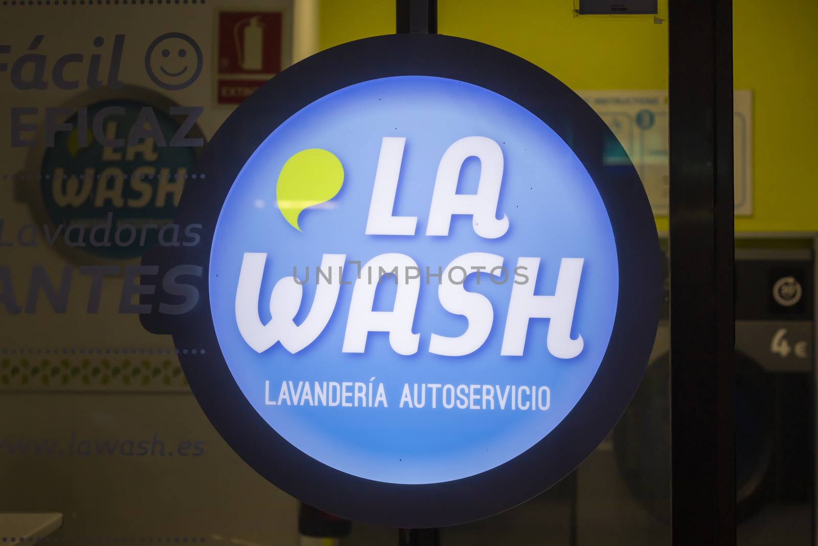 Madrid, Spain - May 19, 2020: The sign located in the window of a self-service laundry on Maiquez street, in the Retiro district.