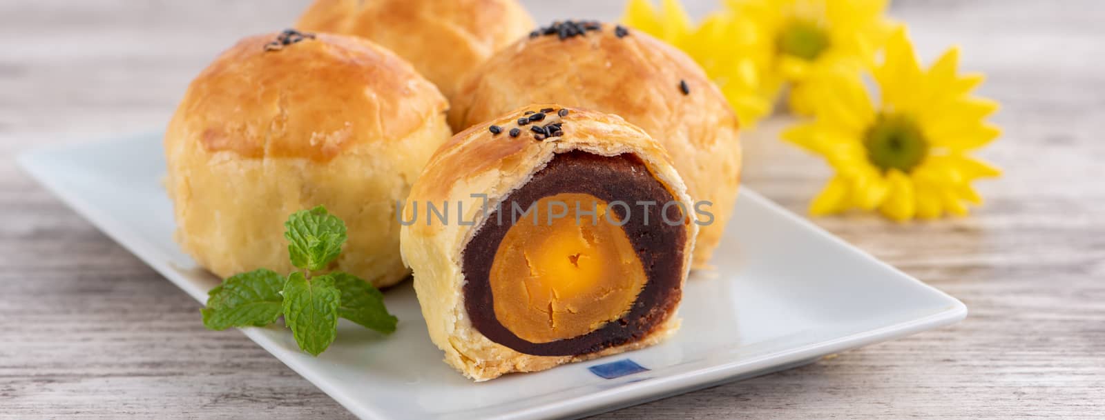 Moon cake yolk pastry, mooncake for Mid-Autumn Festival holiday, top view design concept on bright wooden table with copy space