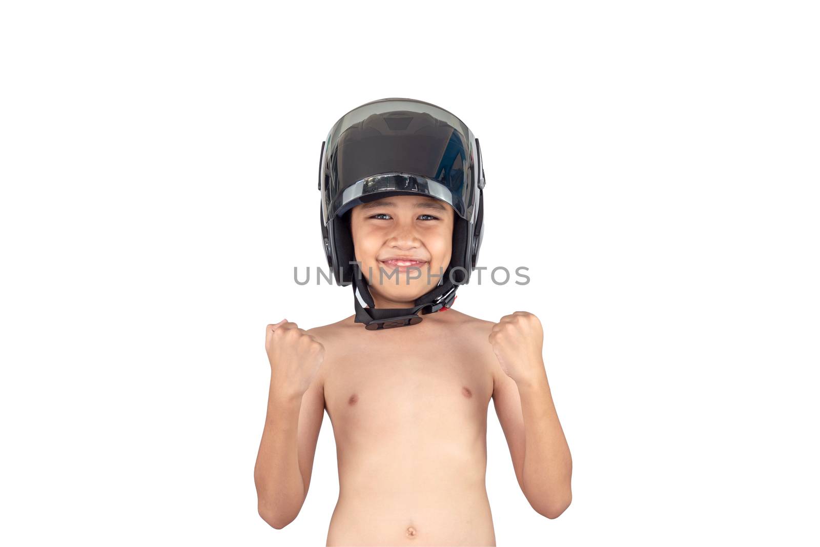 A boy wearing a motorcycle helmet stands smiling but without a shirt isolated on white background.