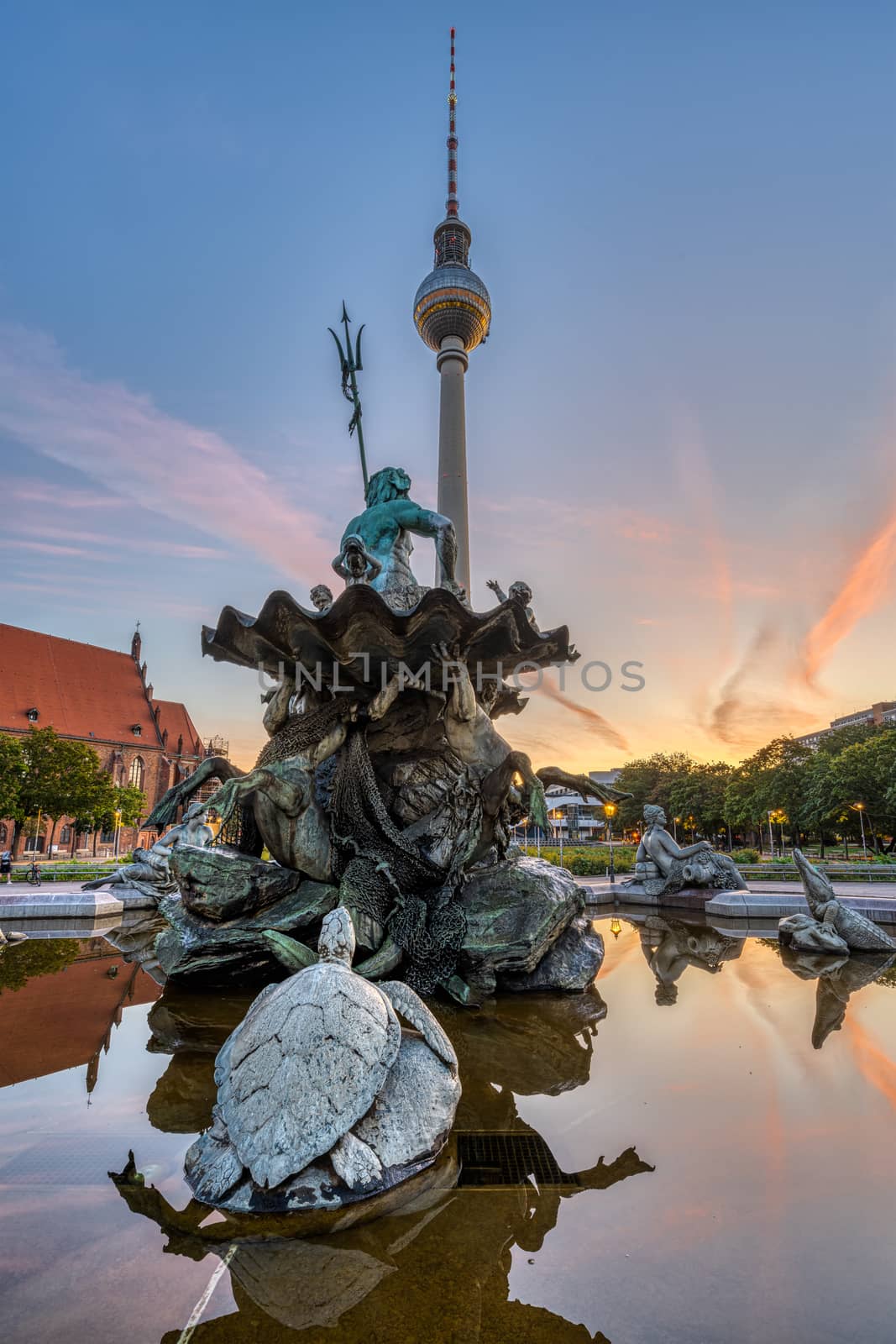 The Television Tower and the Neptune fountain at Alexanderplatz in Berlin before sunrise