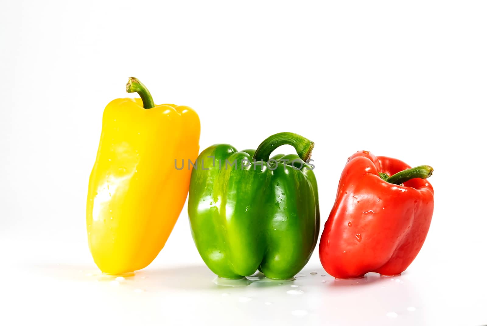 Group of 3 large fresh paprika , green, red, and yellow isolated on white background.