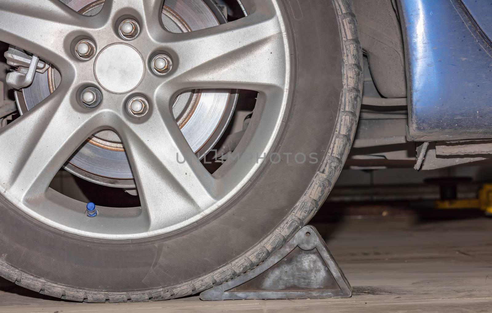 Car wheel on a car, close-up, wheel tuning disk and tire by DamantisZ