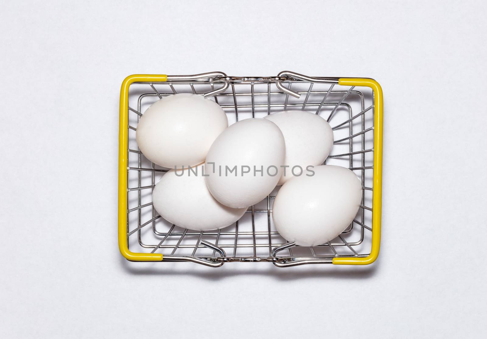Fresh eggs in a shopping basket. Top view. Shopping, purchasing, and food delivery concept. by DamantisZ