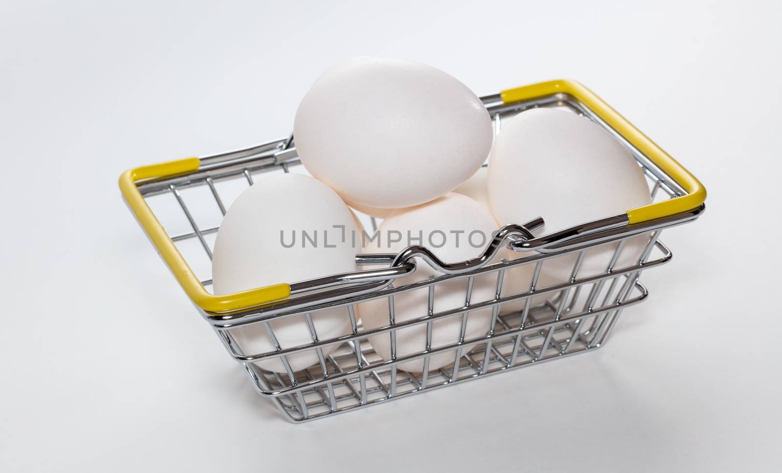 Fresh eggs in a shopping basket. Shopping, purchasing, and food delivery concept. by DamantisZ