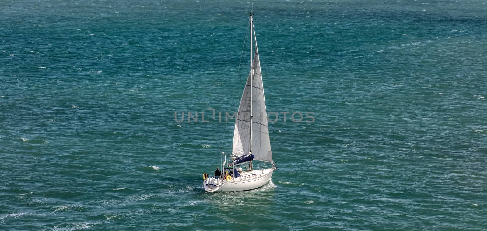 High angle shot of a white sailboat sailing in Weymouth Bay, UK by DamantisZ