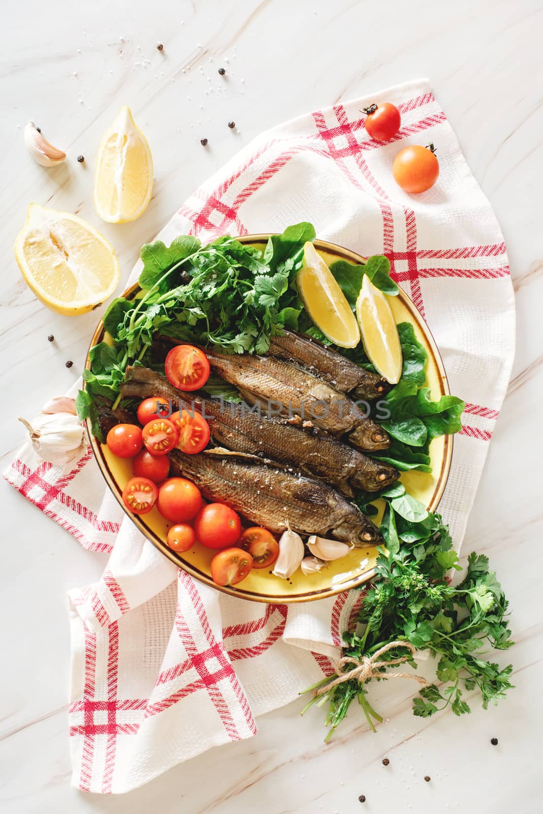 healthy eating. Plate with baked fish and fresh vegetables top view flat lay