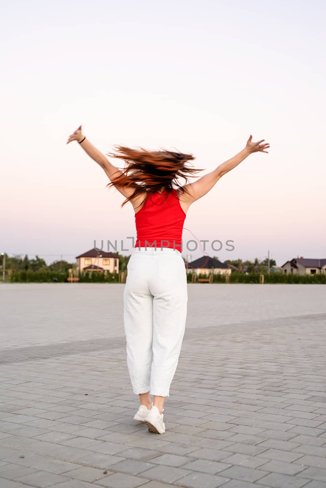 Active lifestyle. Woman dancing at the park turning around