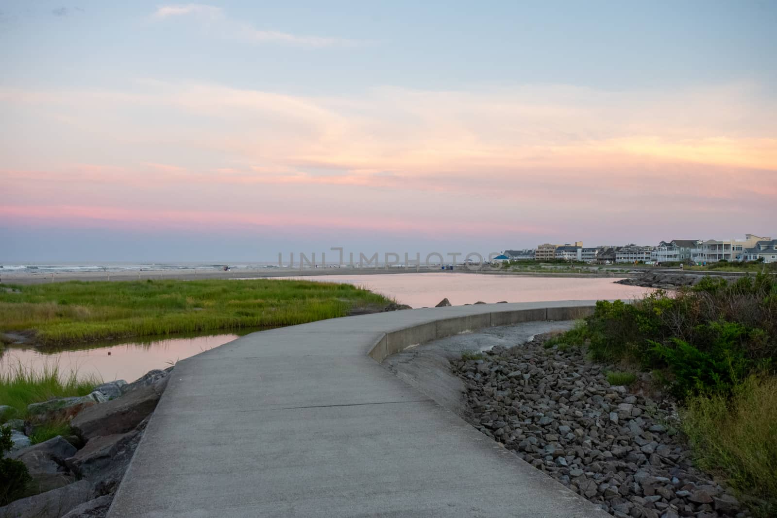 A Concrete Path With an Orange and Blue Sunset Sky Behind It at  by bju12290