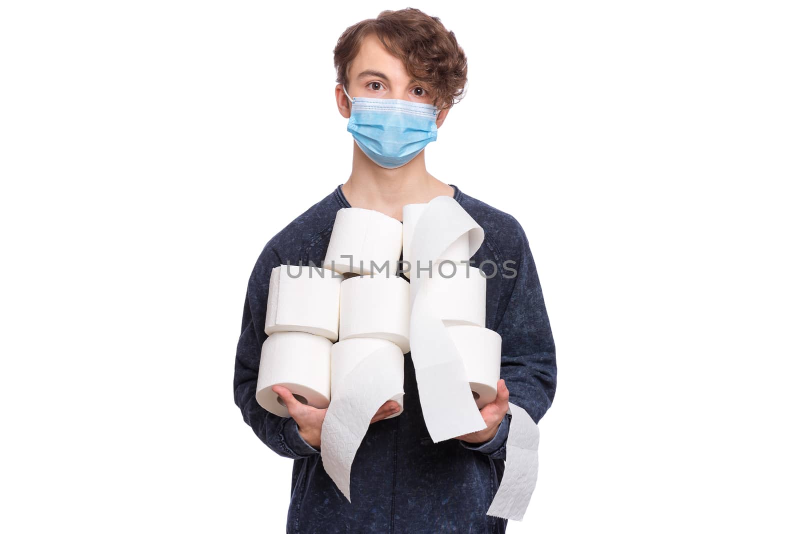 Teen boy wearing medical protective face mask to health protection from influenza virus, isolated on white. Child holds toilet paper.