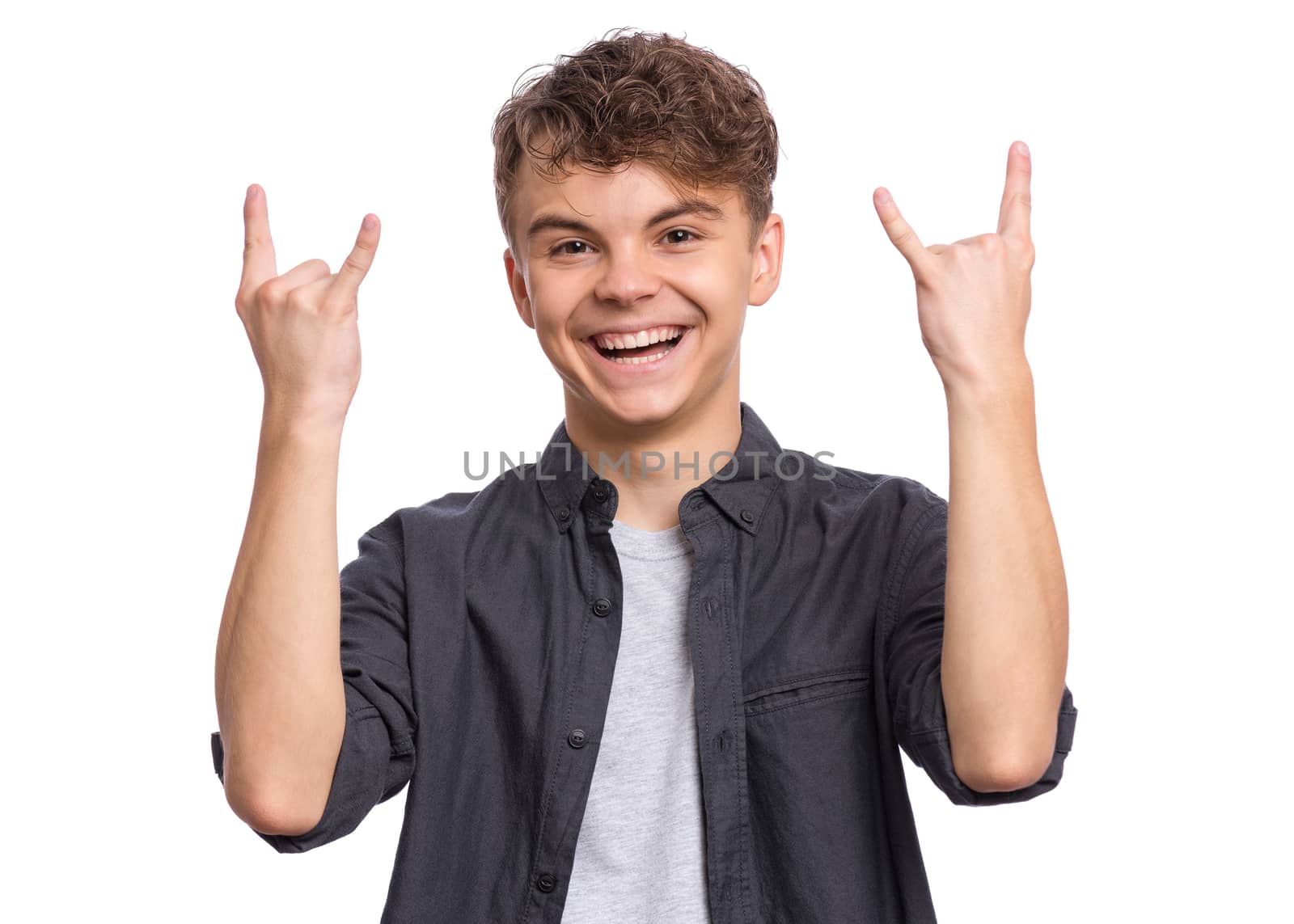 Portrait of handsome teen boy making Rock Gesture. Happy cute child isolated on white background.