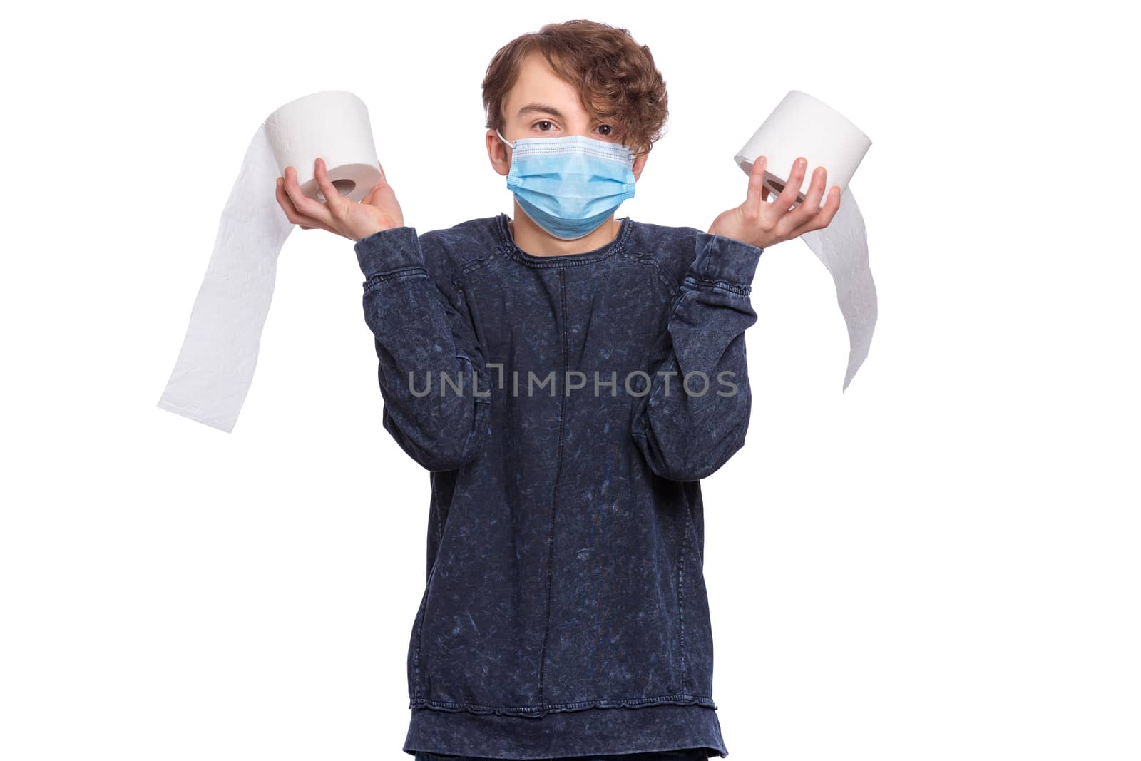 Concept of coronavirus quarantine. COVID-19 - home isolation. Teen boy wearing medical protective face mask to health protection from influenza virus, isolated on white. Child holds toilet paper.