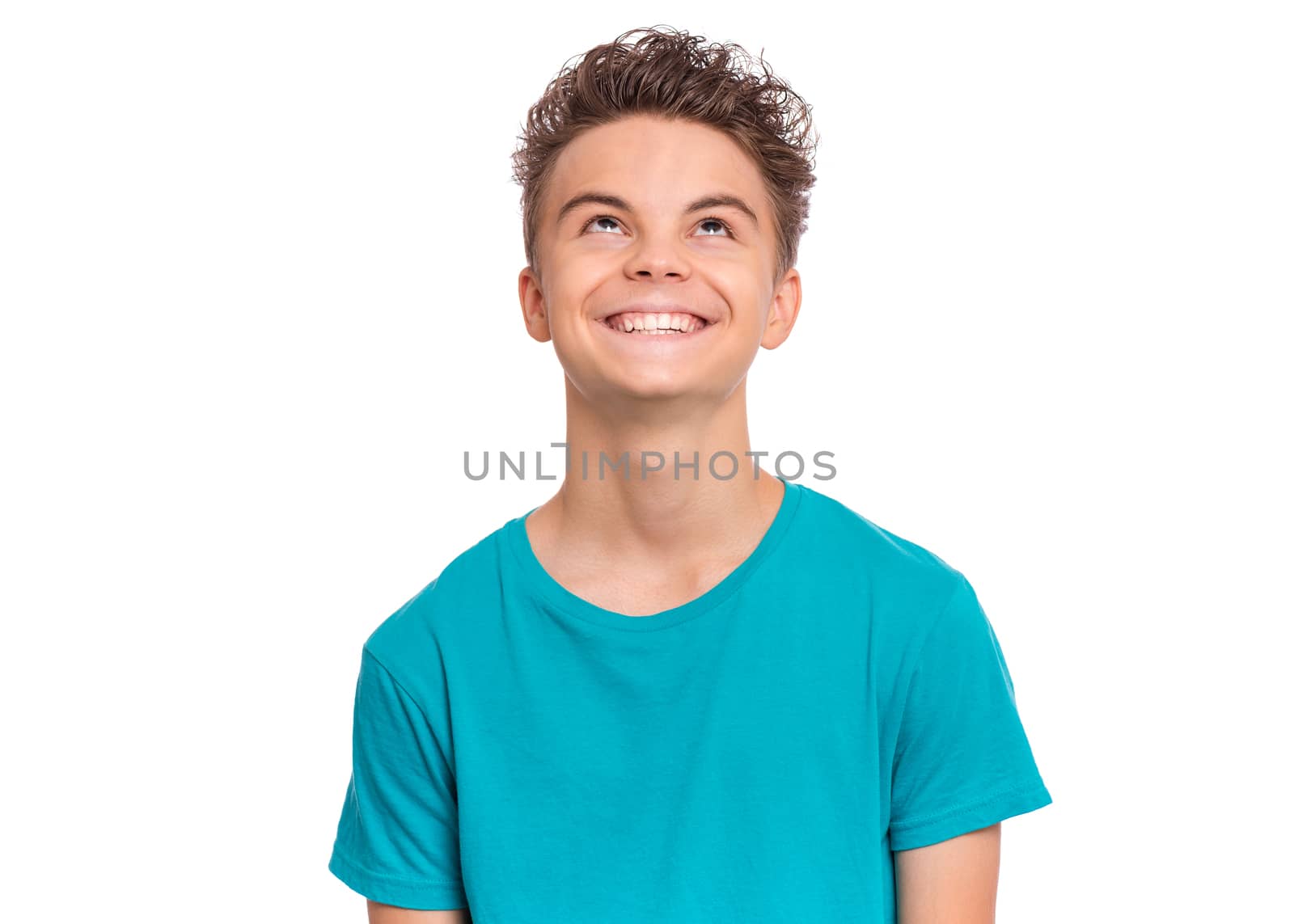 Handsome caucasian Teen Boy in blue t-shirt, isolated on white background. Teenager looking up and smiling. Happy child - close-up portrait.