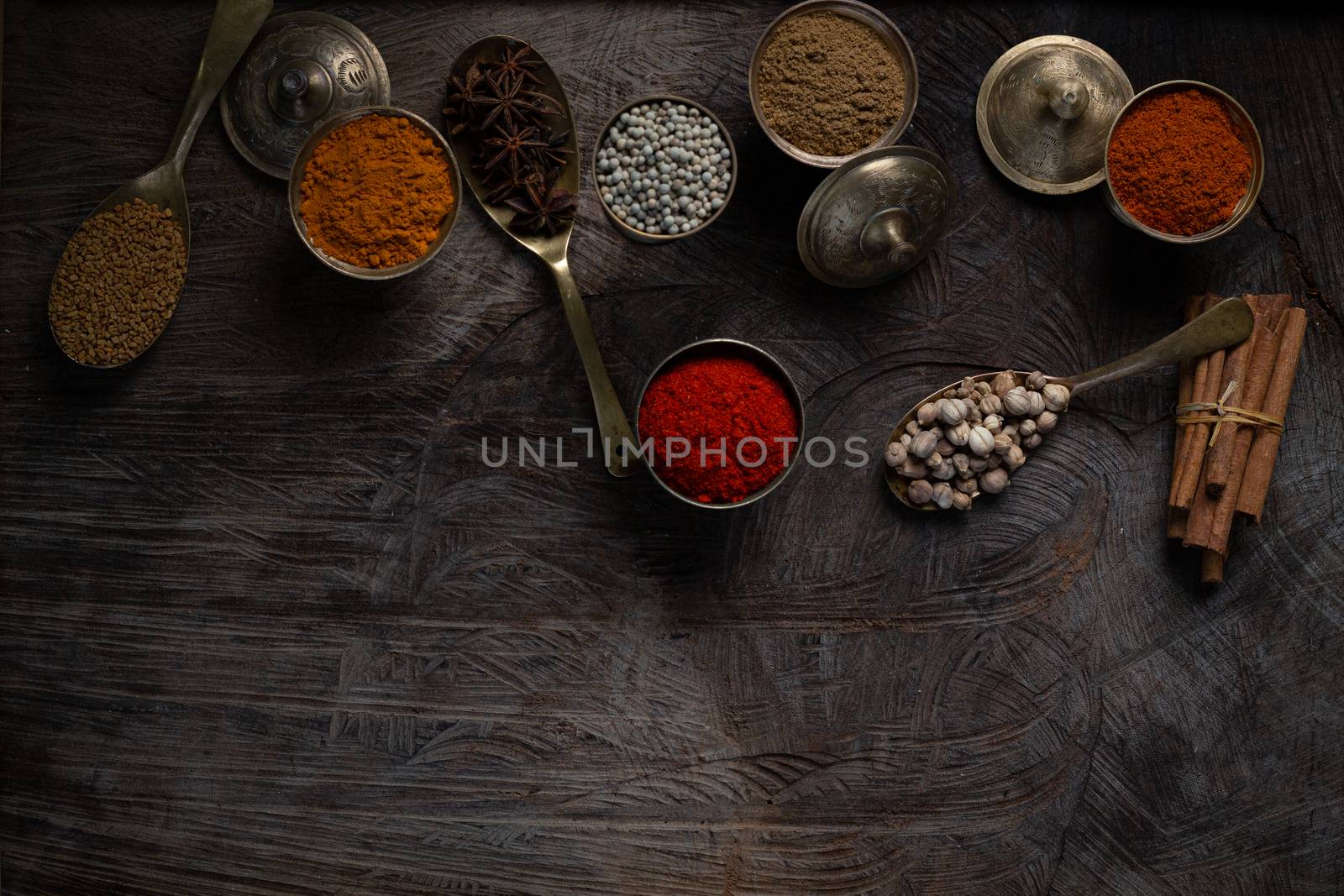 Condiment of indian food Spice garnish background on wood table top view. Seasoning of Asian organic herb cuisine flavour in kitchen board, chilli spicy taste concept